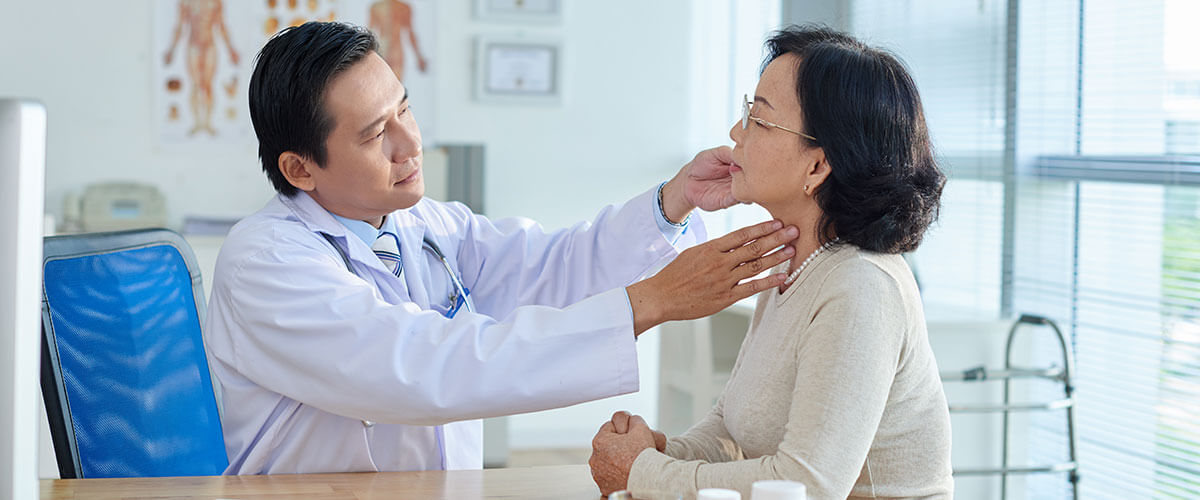 doctor checking an older lady's neck