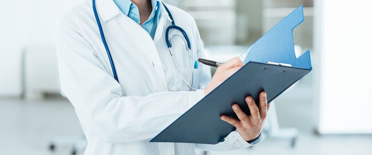 doctor's hands holding blue folder