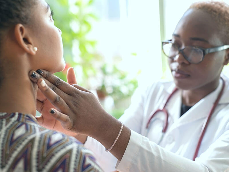 doctor examining a woman's lymph nodes